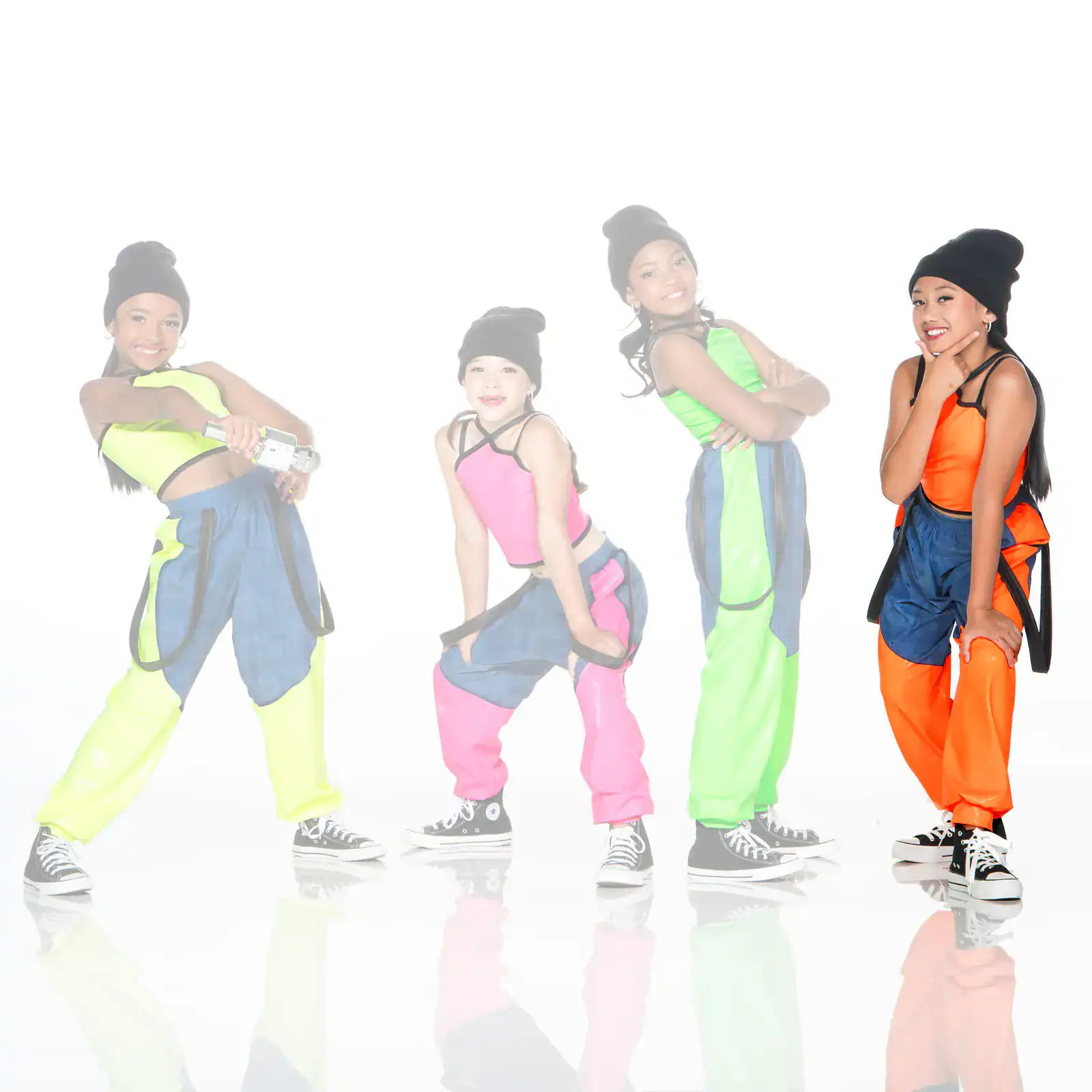Four young dancers in colorful streetwear pose against white background.