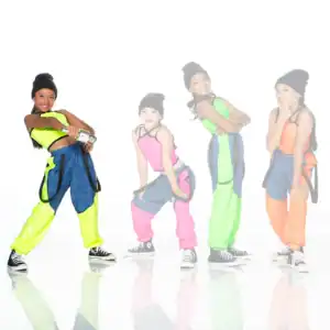 Four girls in colorful hip-hop outfits pose on white background.