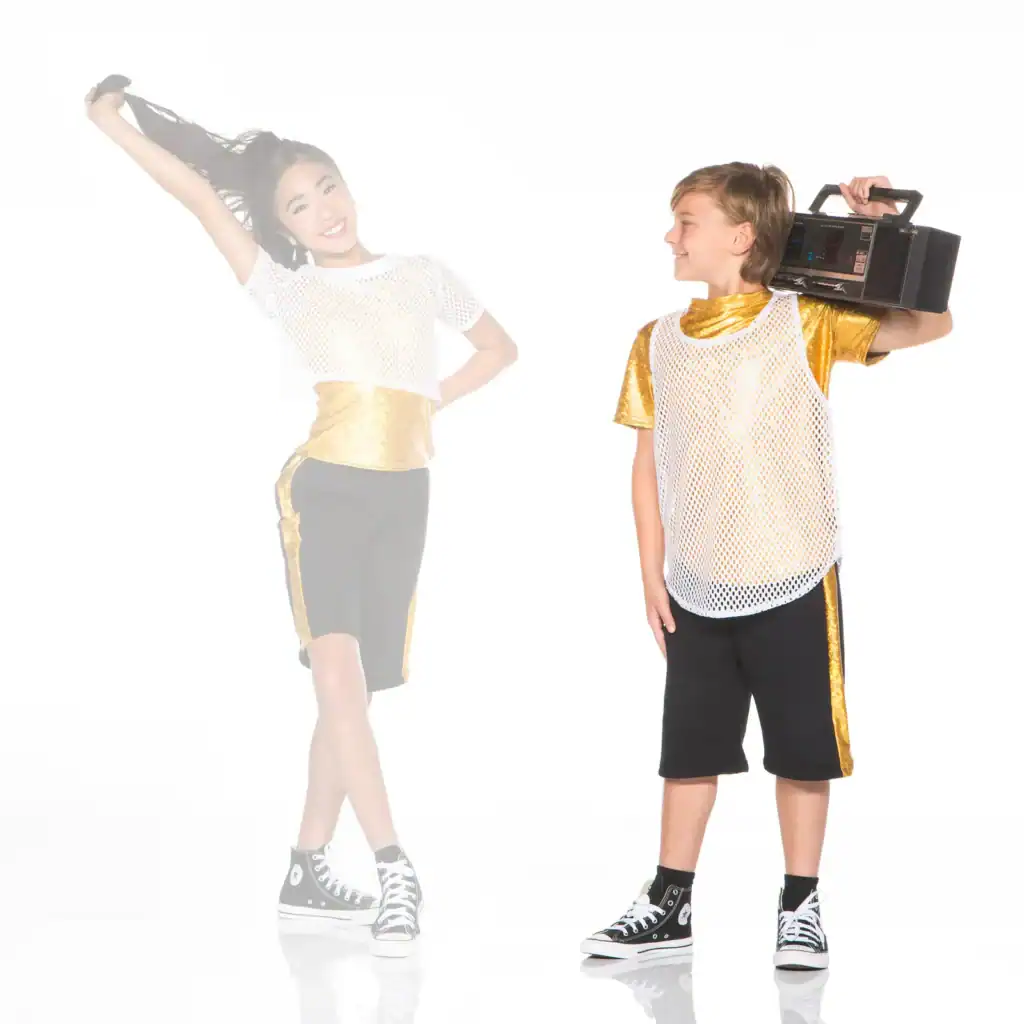 Two children in gold outfits, one holding a boombox