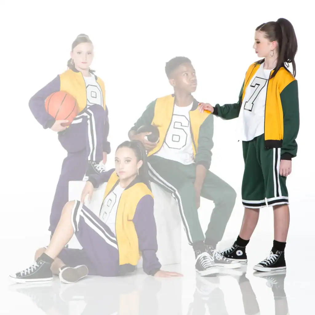Four teens in varsity outfits posing with basketballs