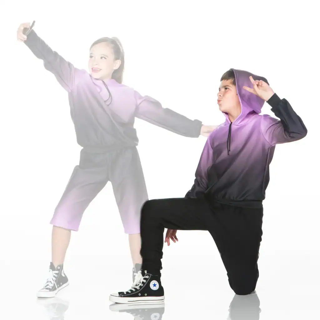 Two children in purple hoodies posing against white background