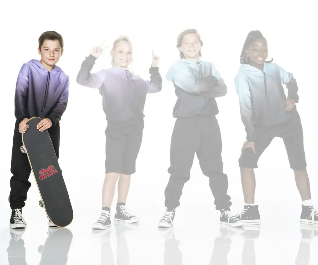 Four children in hoodies pose with a skateboard.