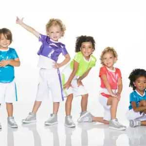 Five children wearing colorful dance outfits and silver sneakers