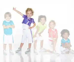 Five children wearing colorful shiny shirts and white shorts