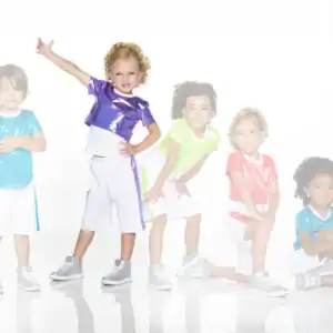 Five children wearing colorful shiny shirts and white shorts