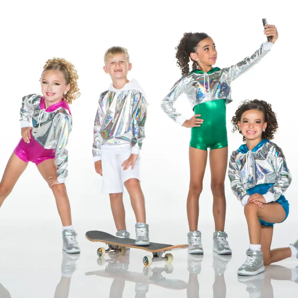 Four children wearing metallic hoodies and colorful outfits pose together.