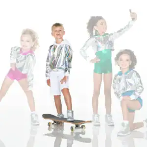 Four children wearing metallic hoodies pose with skateboard and phone.