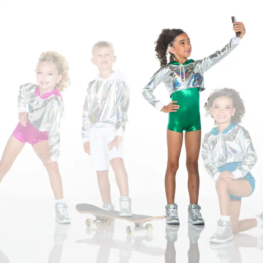 Four children in metallic outfits posing with skateboard and phone