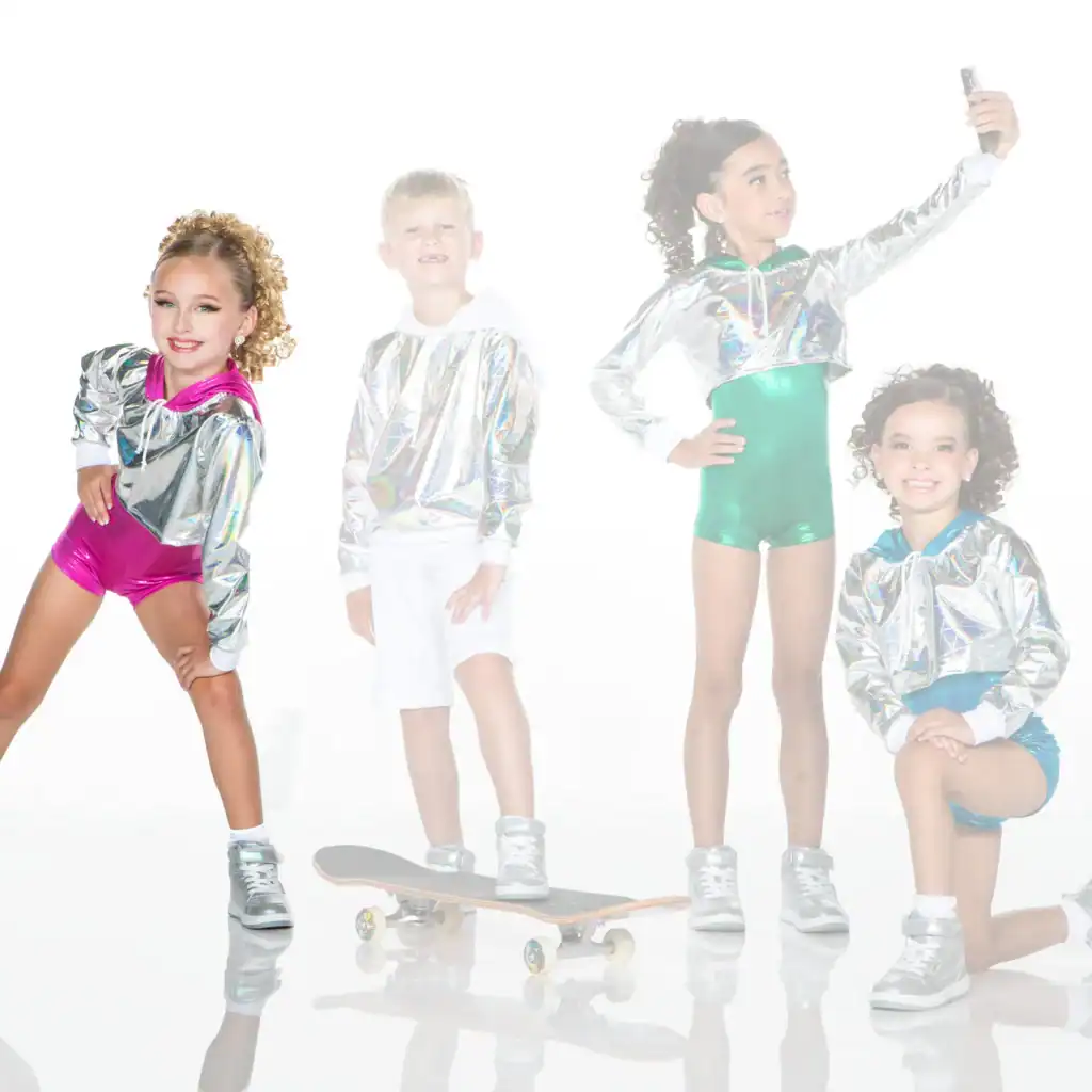 Four children in metallic outfits pose with skateboard and phone.