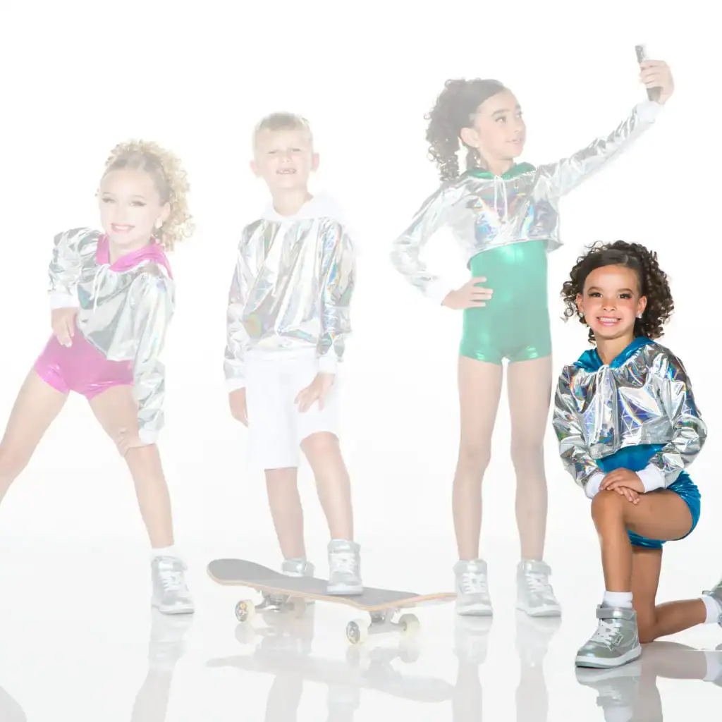 Four children wearing silver jackets pose with skateboard and phone.