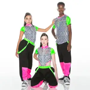 Three dancers in neon checkerboard costumes pose against white background.