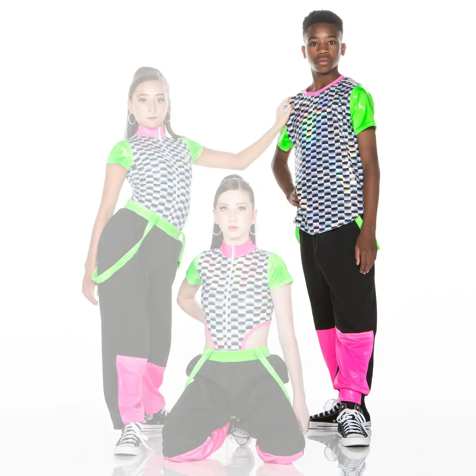 Three dancers in neon checkered outfits pose against white background.