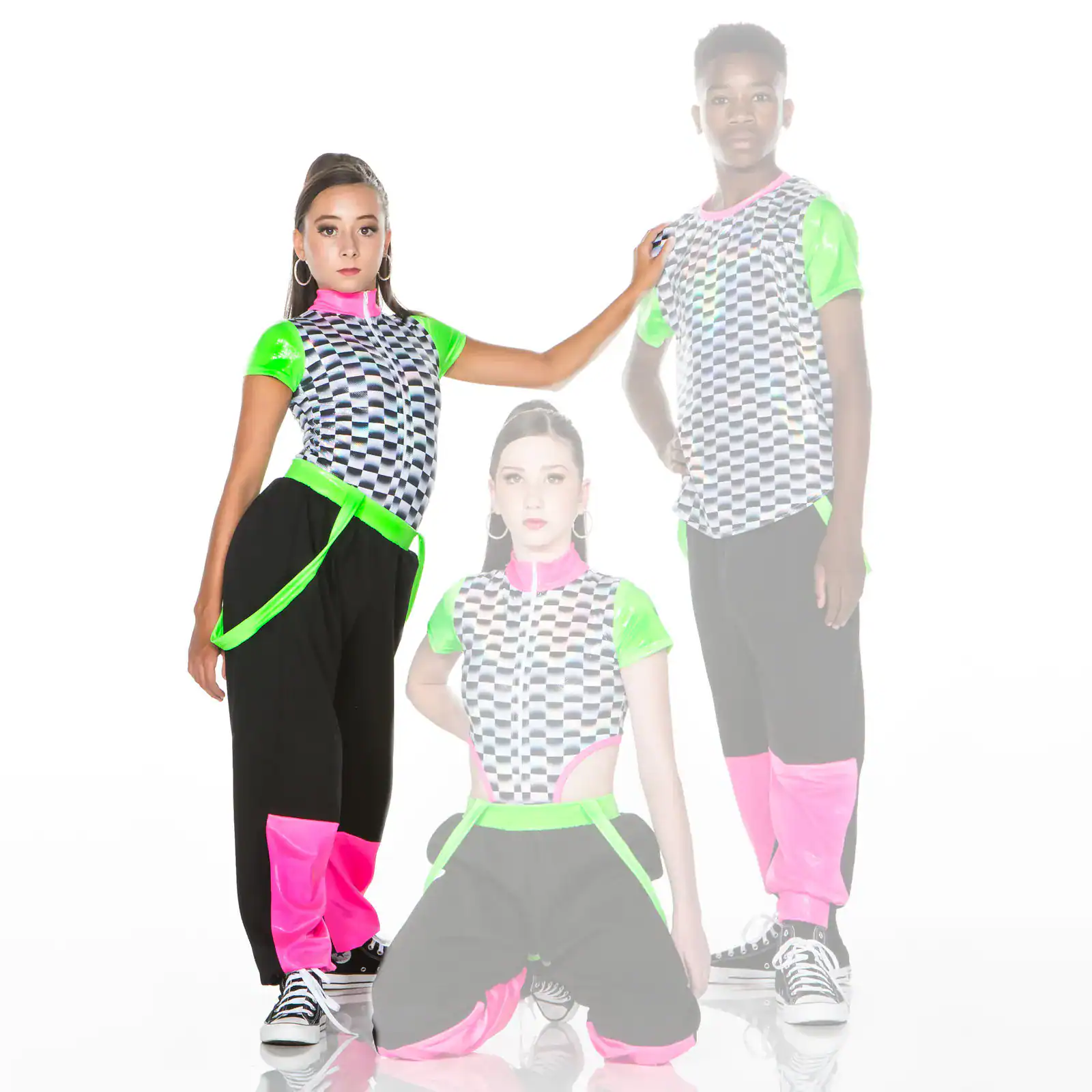 Three dancers in neon checkerboard costumes pose together.