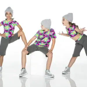 Three girls in colorful geometric shirts and gray beanies