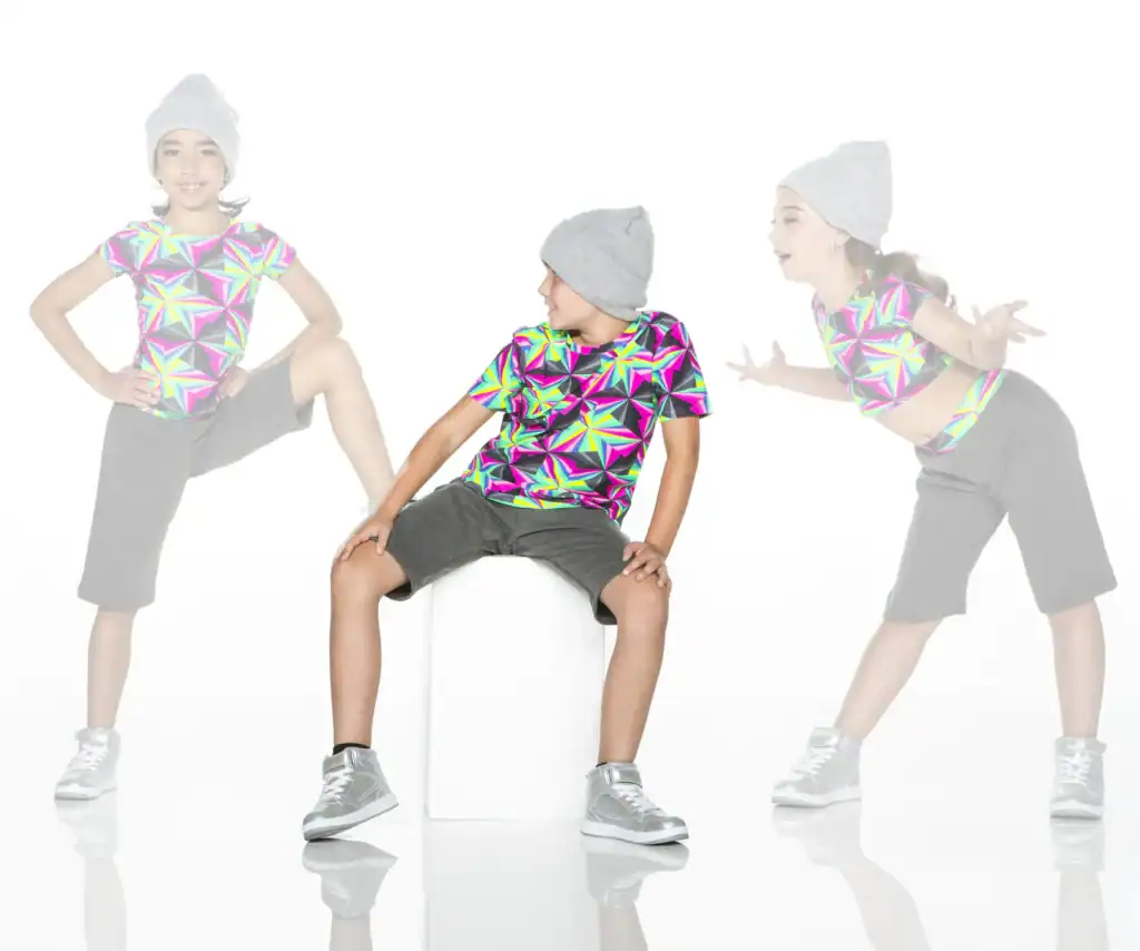 Three children modeling colorful geometric shirts and gray beanies