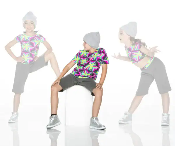 Three children modeling colorful geometric shirts and gray beanies