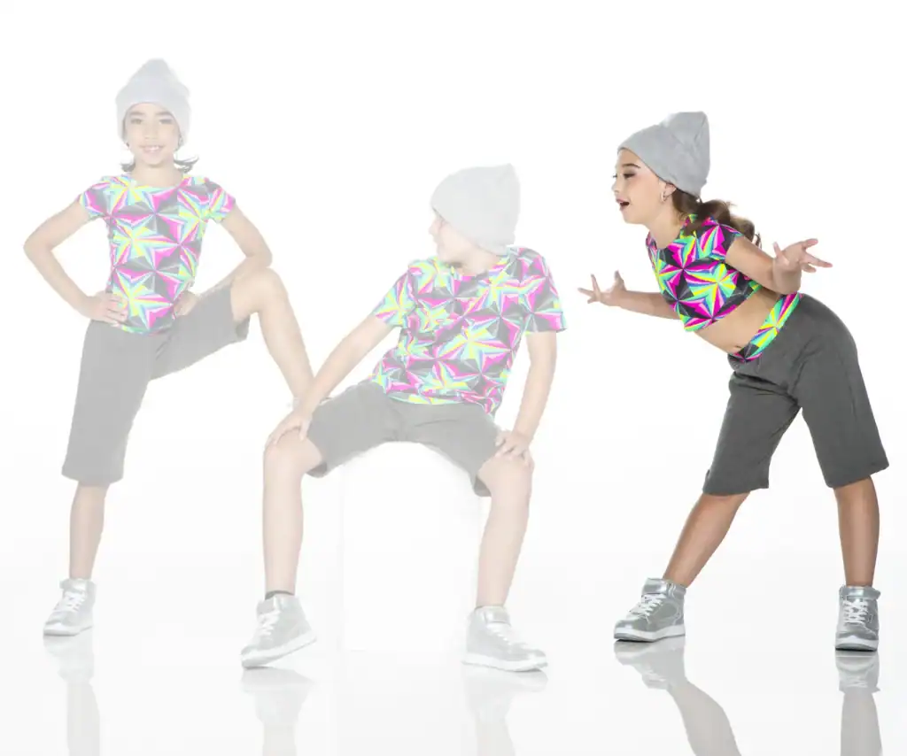 Three children pose in colorful geometric shirts and gray beanies.