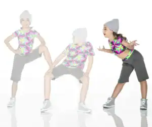 Three children pose in colorful geometric shirts and gray beanies.