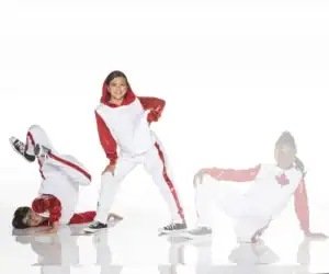 Three dancers in red and white costumes posing