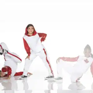 Three dancers in red and white costumes posing