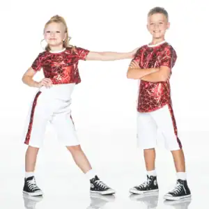 Two children modeling matching red shirts and white shorts