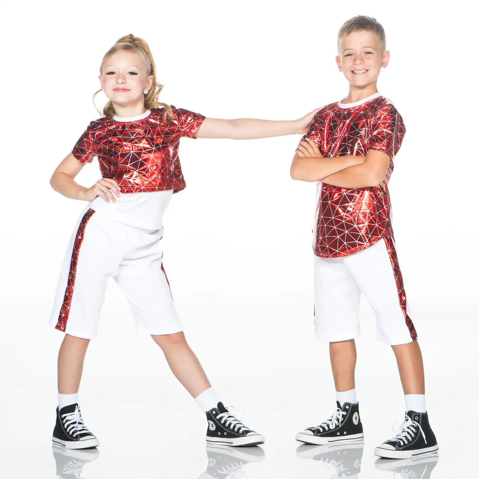 Two children modeling matching red shirts and white shorts