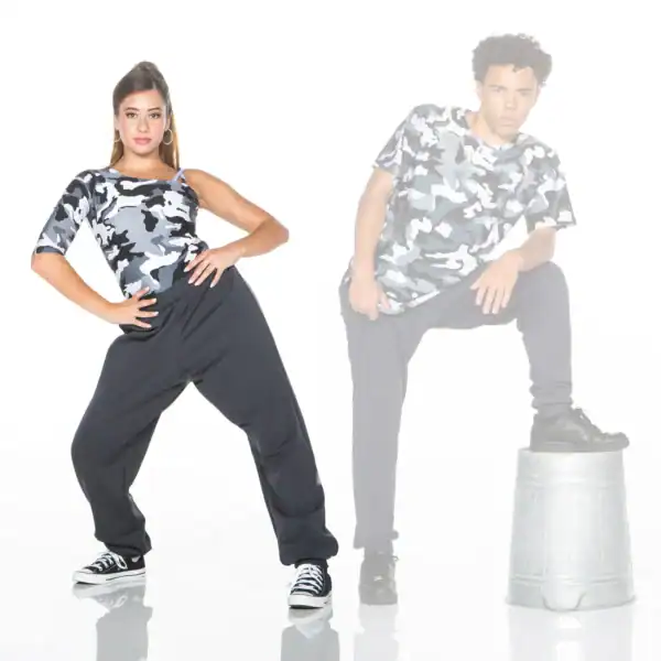 Two dancers wearing camouflage tops pose against a white background.
