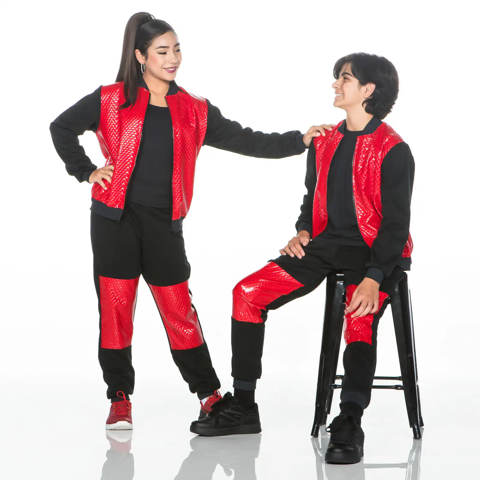 Two people wearing matching red and black outfits