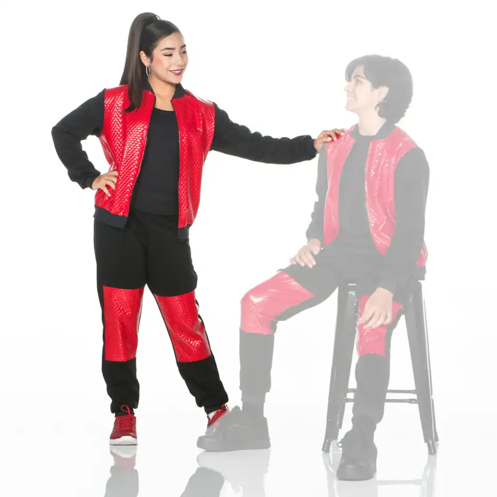 Woman wearing red and black outfit beside faded seated man