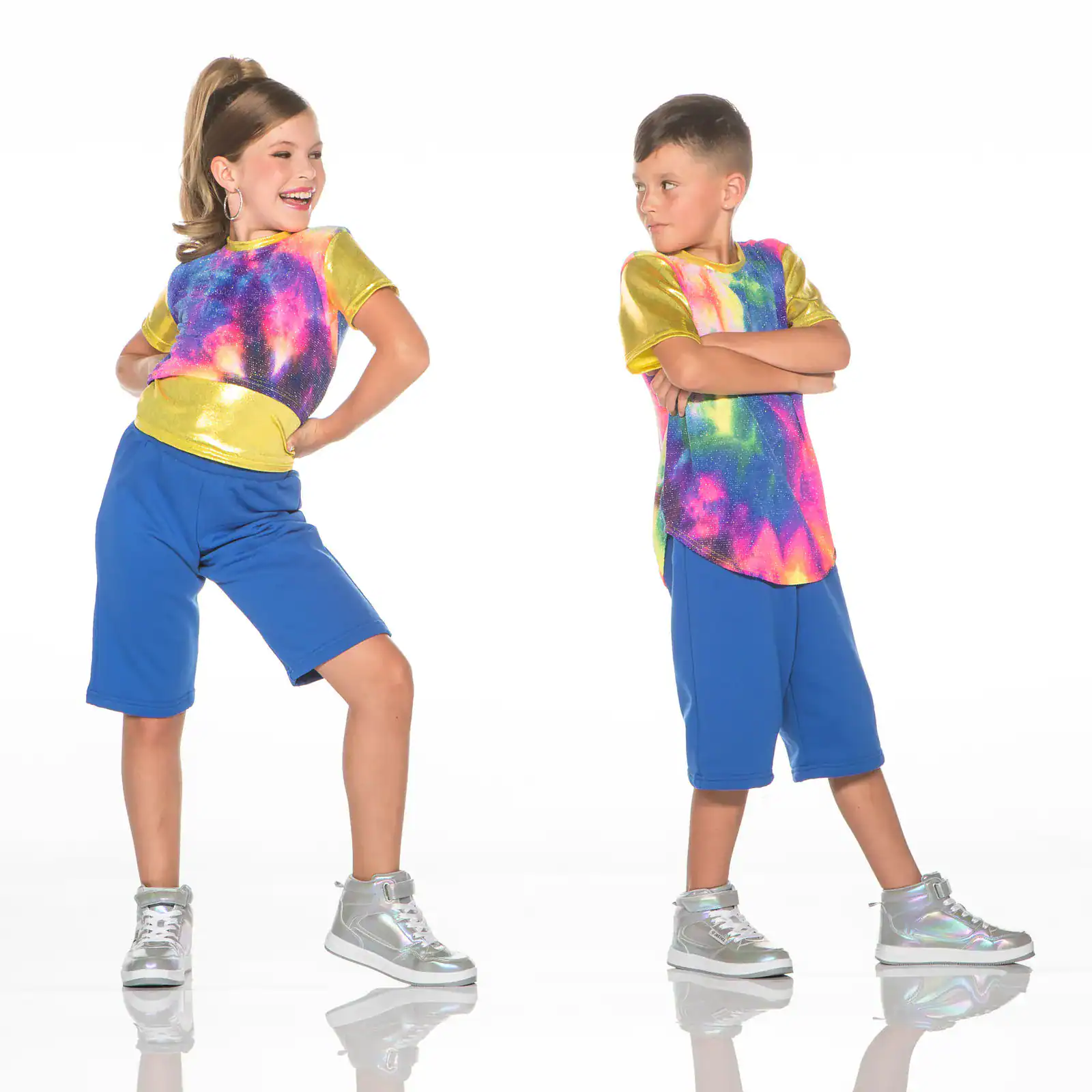 Two children modeling colorful galaxy-print dance outfits