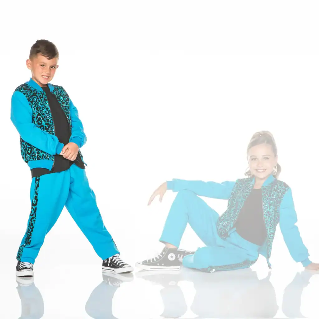 Two children wearing matching turquoise leopard-print dance outfits