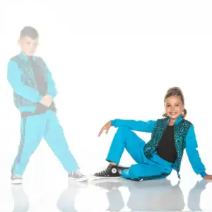 Two children in matching turquoise leopard-print dance outfits