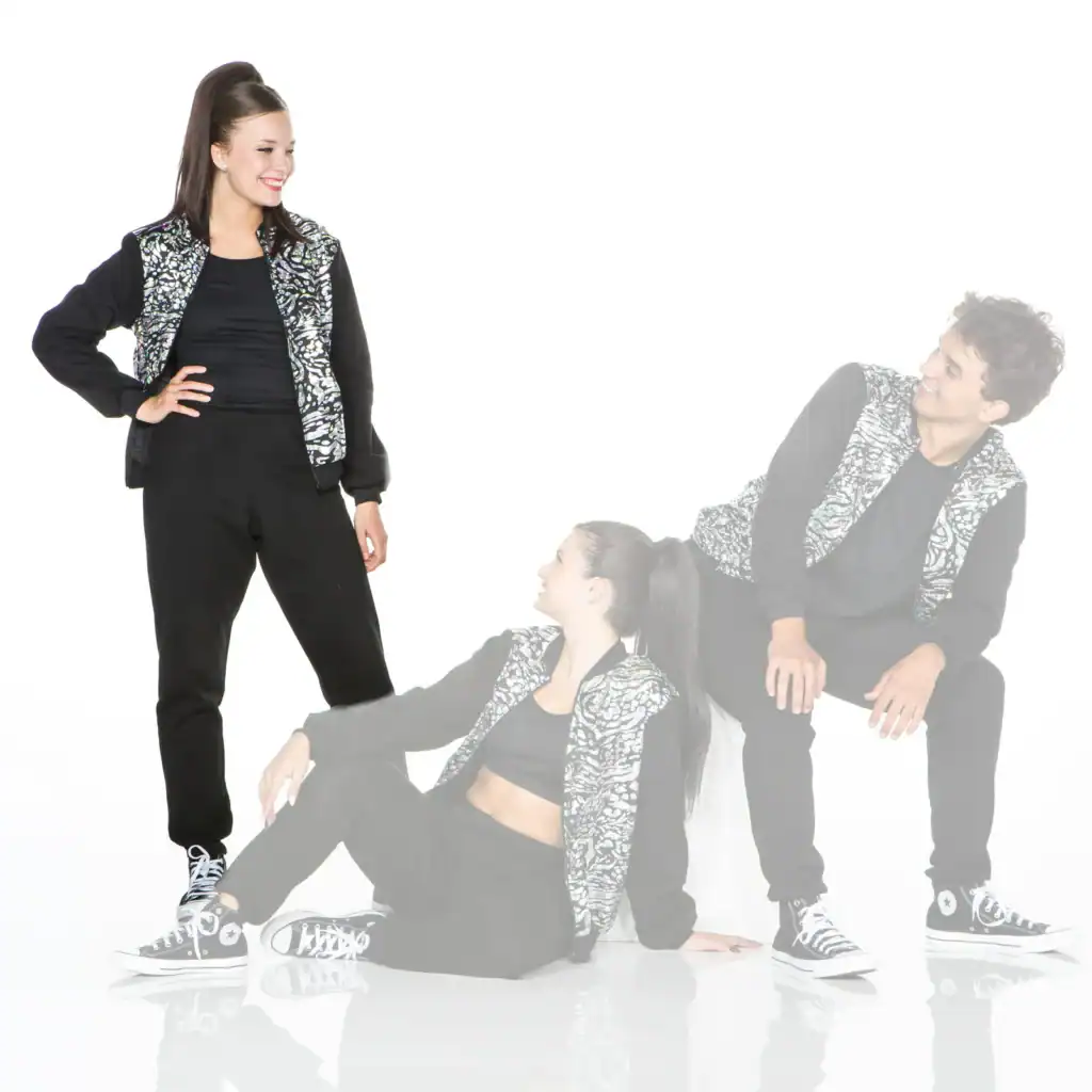 Three dancers in matching black outfits with patterned vests