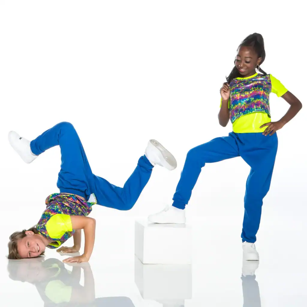 Two dancers in colorful outfits pose against a white background.