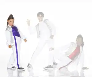 Three children posing in colorful dance outfits on white background