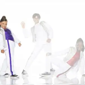 Three children posing in colorful dance outfits on white background