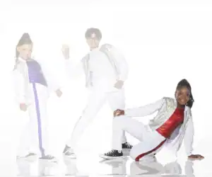 Three children posing in white and sequined dance outfits