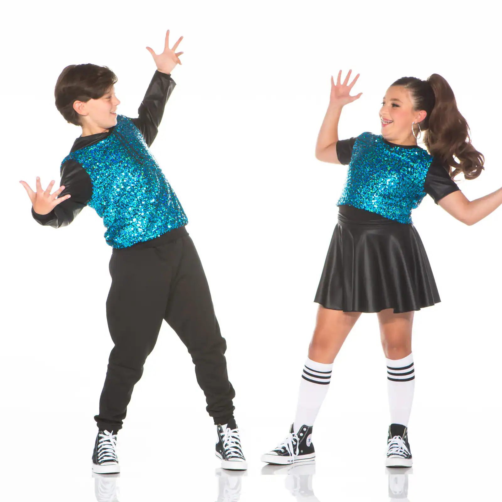 Two children dancing in matching blue sequined tops