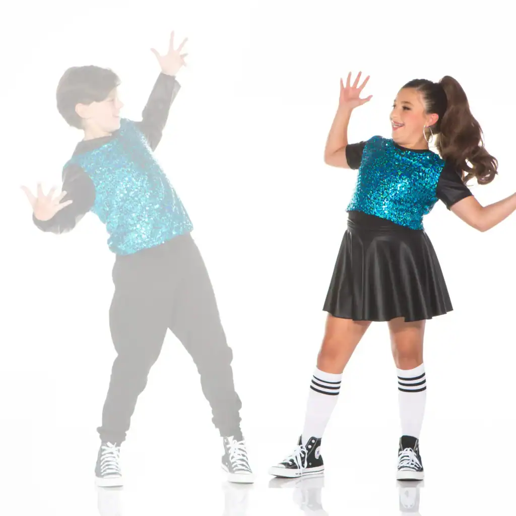 Two children dancing in matching blue sequined outfits
