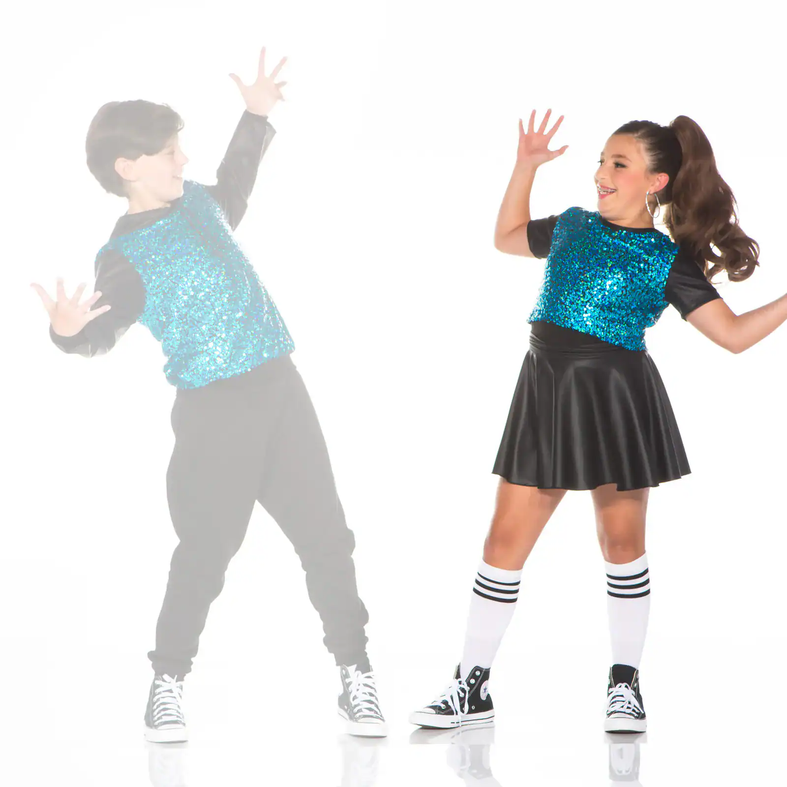 Two children dancing in matching blue sequined outfits