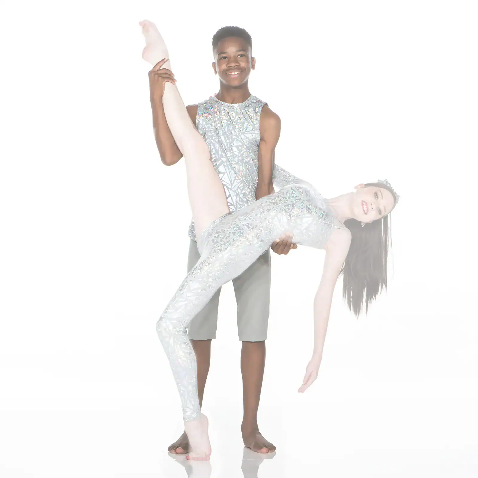 Dancer lifts partner in sparkling silver costumes