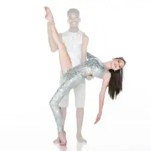 Dancers in silver costumes performing an acrobatic lift