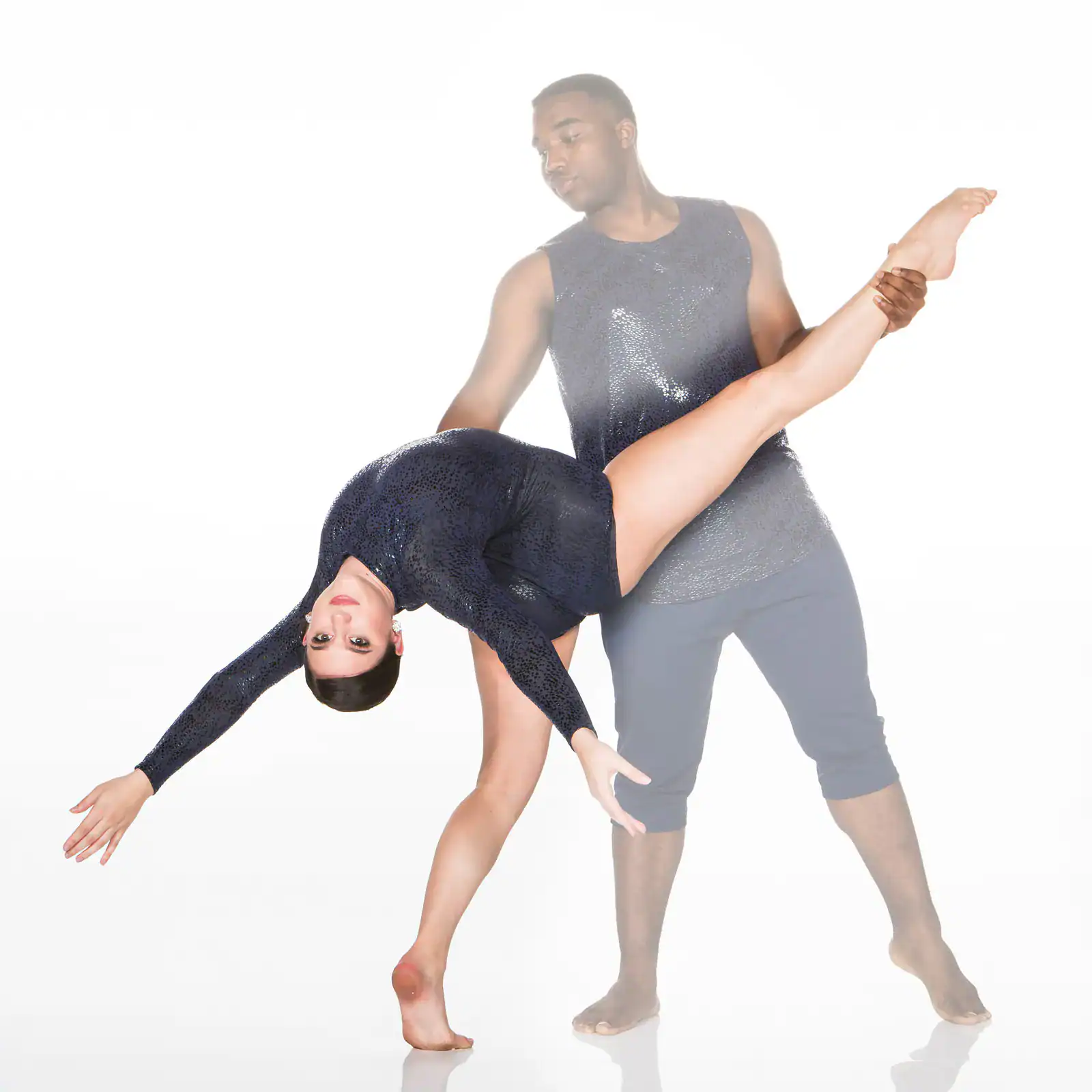 Male dancer lifts female dancer in an acrobatic pose