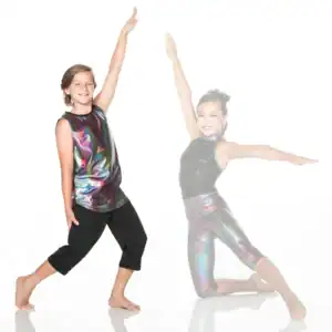 Two young dancers pose in shimmering performance outfits.