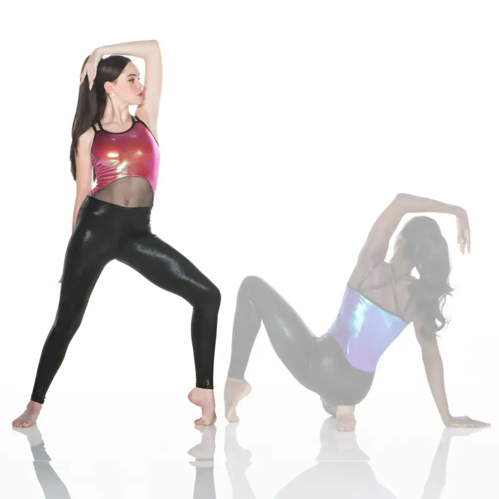 Two women pose in shiny dancewear against a white background.