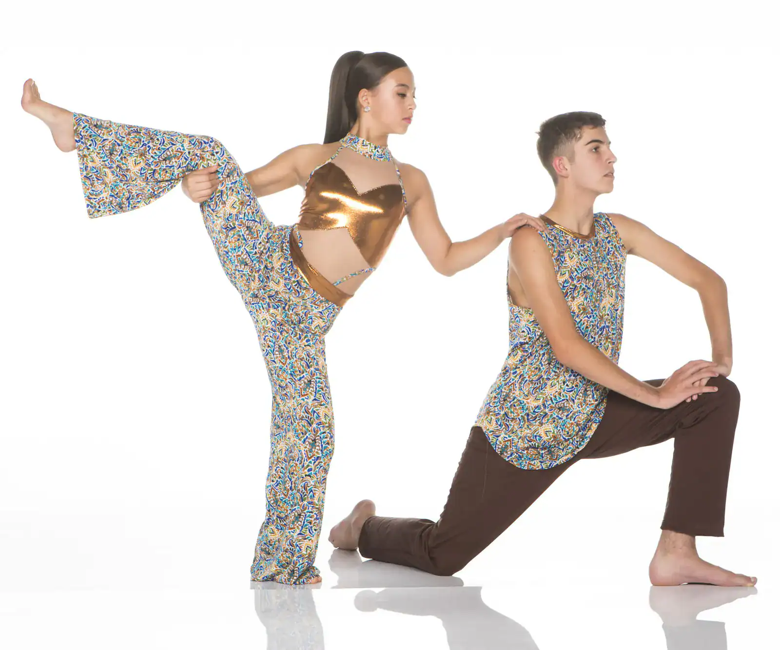 Two dancers pose in colorful patterned costumes.