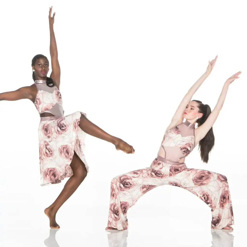 Two dancers pose in matching floral costumes.