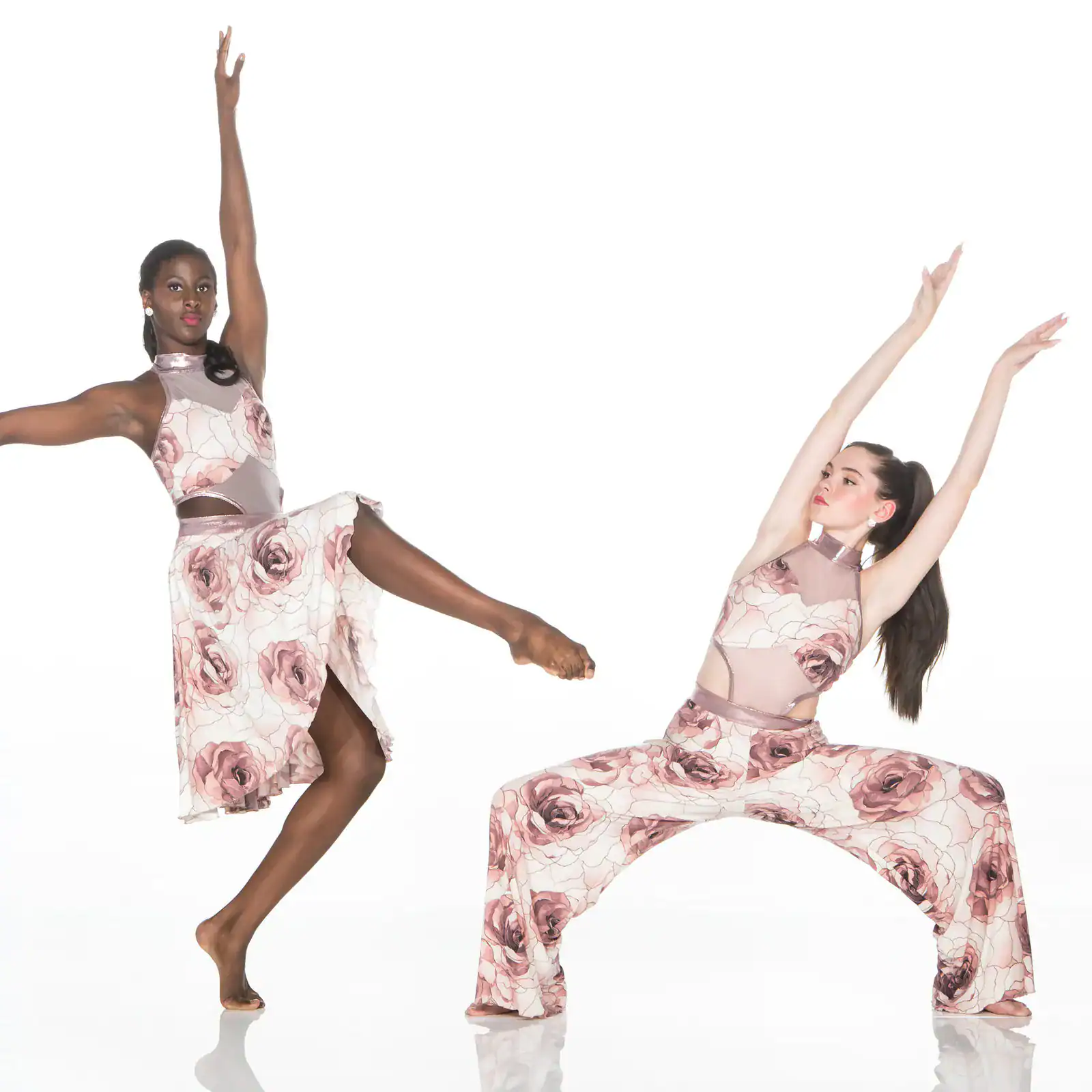 Two dancers pose in matching floral costumes.