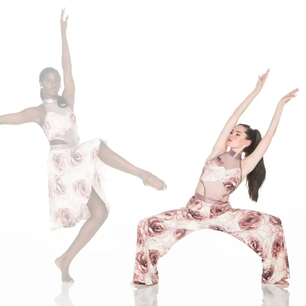 Two dancers pose in matching floral costumes against white background.