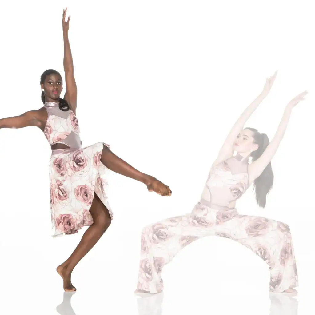 Two dancers pose in matching floral costumes against white background.